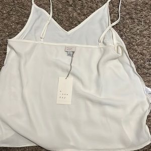 A New Day White tank